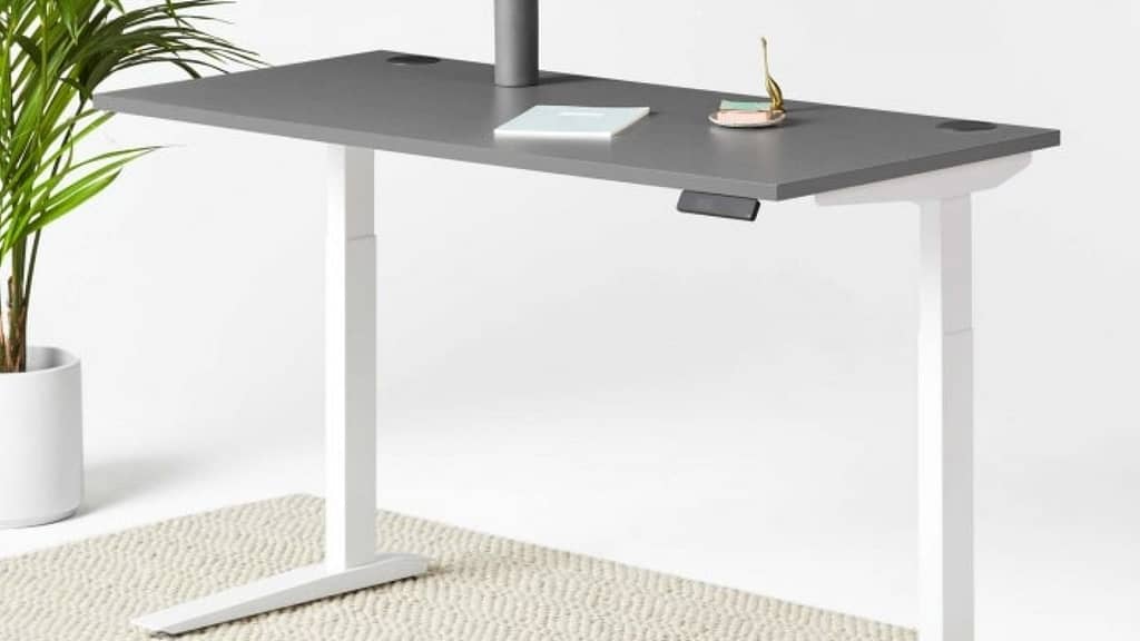 A white Jarvis sit-stand desk against a white background with grey countertop
