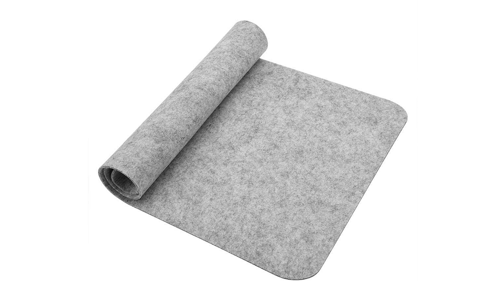 A large grey Richer Mouse Pad half rolled up against a clear background