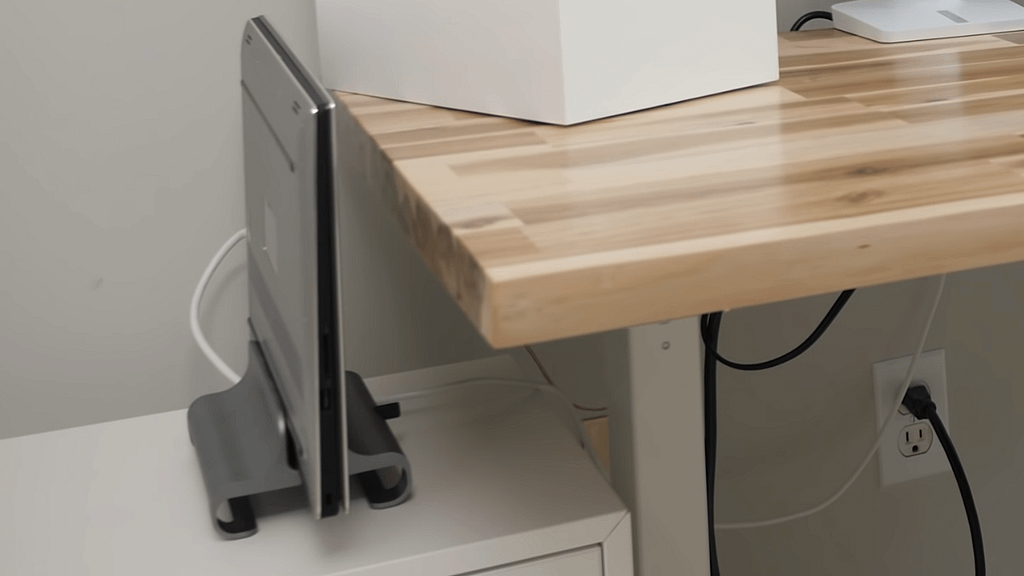 Silver Satechi Universal Laptop Stand holding a dell laptop next to a natural wooden desk