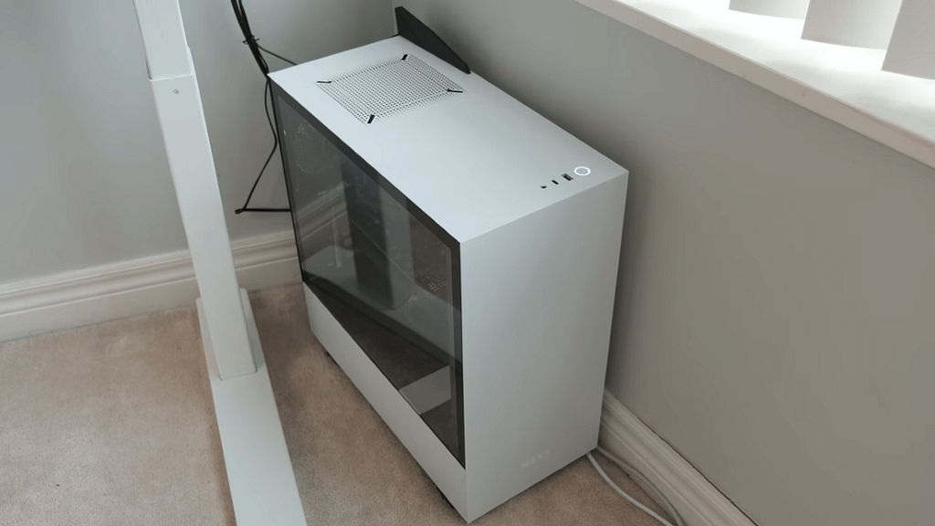 A white NZXT H510 computer case completing the minimalist home office design